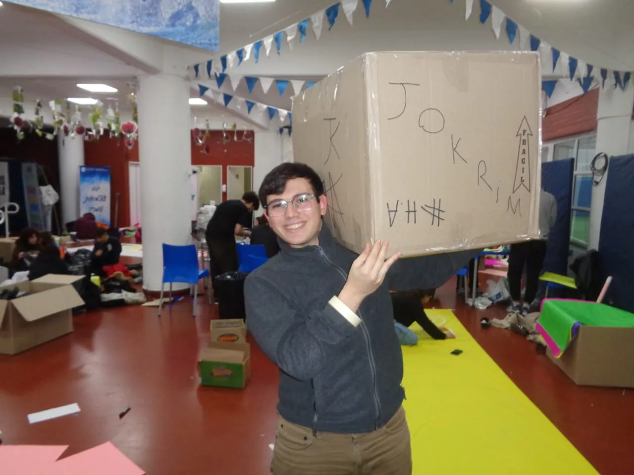 Mati holding a cardboard box on materials day