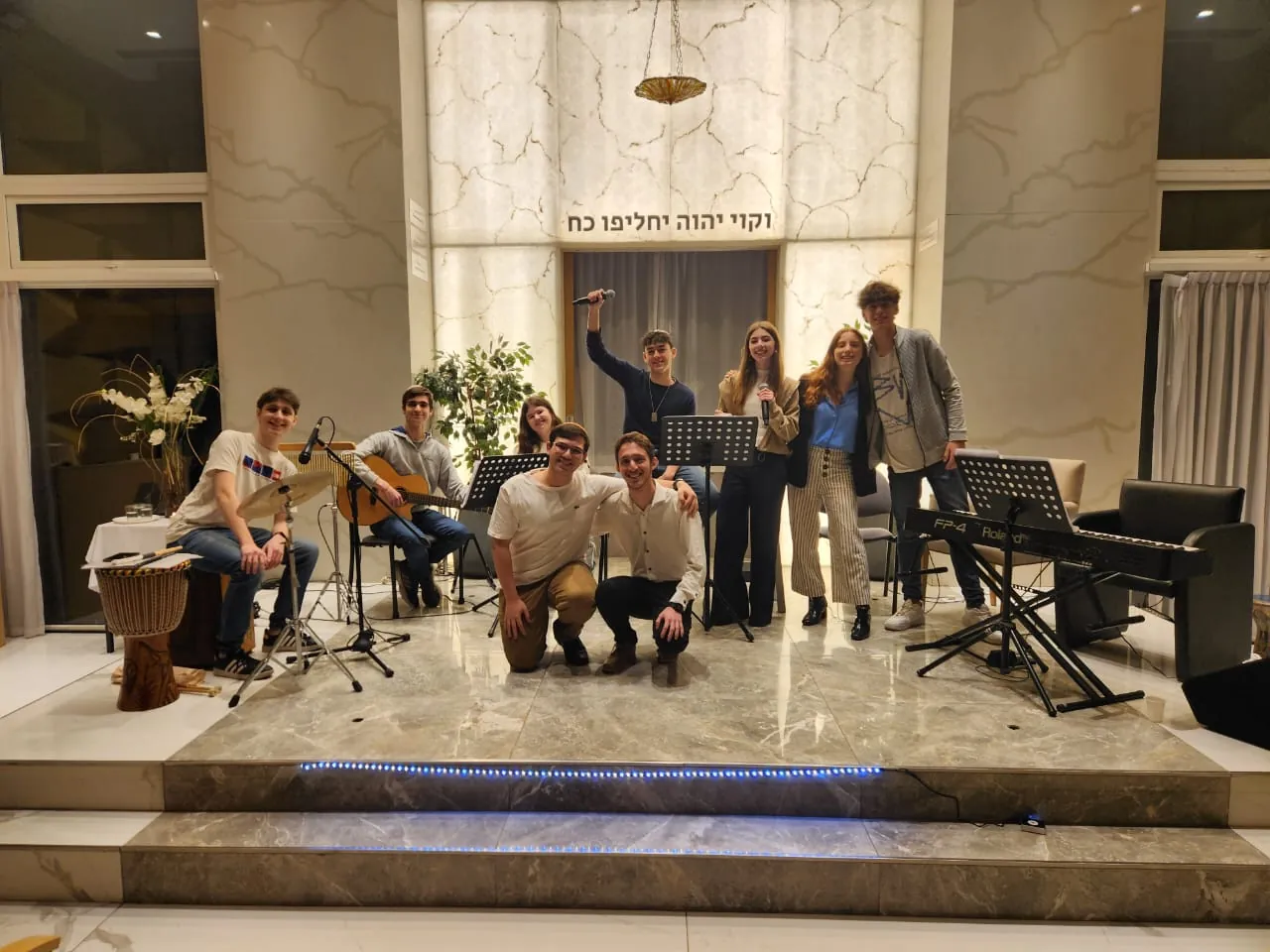 A group of young people with instruments before a youth Kabbalat Shabbat
